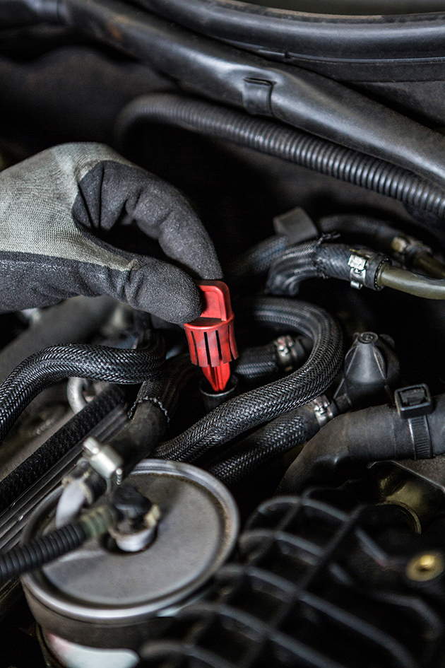 Close-up of mechanic servicing car engine at repair garage